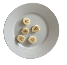 Five banana slices on a plate