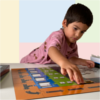 Child moving a variable block over Codidactic coding board game